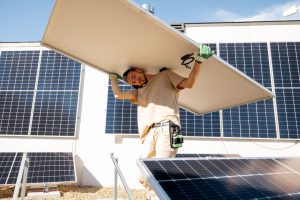 Man installing solar panels on a rooftop